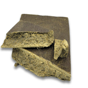 Moroccan Gold import style hash slab with broken pieces showing sandy-gold interior and soft crumbly texture