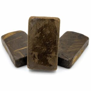 Static hash pressed slabs fanned on white background showing smooth chocolate brown resin surface