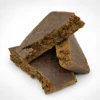 Freak Street hash slab, three dark brown dense pieces stacked on a white background with rough broken edges